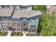 Aerial view of modern townhome showcasing brick and siding facade, professional landscaping, and inviting entrance at 8245 Bostic Dr, Fishers, IN 46038