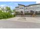 Exterior view of modern townhomes featuring individual garage doors and private decks overlooking a yard at 8245 Bostic Dr, Fishers, IN 46038