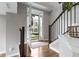 Bright foyer with hardwood floors, staircase, and an open view to the outdoors at 8245 Bostic Dr, Fishers, IN 46038