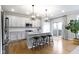 Modern kitchen with granite countertops, stainless steel appliances, and a center island with pendant lighting at 8245 Bostic Dr, Fishers, IN 46038