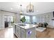 Open concept kitchen with an island, stainless appliances, and easy access to living area and outdoor balcony at 8245 Bostic Dr, Fishers, IN 46038