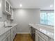 Bright kitchenette with white cabinets, granite countertops, subway tile, and stainless steel appliances at 8245 Bostic Dr, Fishers, IN 46038