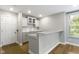 Charming kitchenette featuring white cabinets, granite countertops, and wood flooring at 8245 Bostic Dr, Fishers, IN 46038