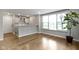 Open-concept living area featuring hardwood floors, ample natural light, and a seamless flow to the kitchen at 8245 Bostic Dr, Fishers, IN 46038