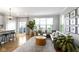 Bright living room with access to an outdoor balcony, seating area, and hardwood floors at 8245 Bostic Dr, Fishers, IN 46038