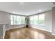 Sunlit living room with beautiful hardwood floors and large windows, creating an airy atmosphere at 8245 Bostic Dr, Fishers, IN 46038