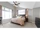 Serene main bedroom with a ceiling fan, two windows, and soft neutral tones create a relaxing retreat at 8245 Bostic Dr, Fishers, IN 46038