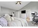Main bedroom suite with a work desk, large bed, and walk through to en-suite bath and closet at 8245 Bostic Dr, Fishers, IN 46038