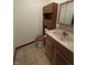 Cozy bathroom featuring ceramic tile floors, wood vanity, and matching storage at 830 Millerwood Dr, Lebanon, IN 46052