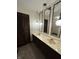 Bathroom with double vanity, decorative hanging light fixtures, and wooden louvered closet doors at 830 Millerwood Dr, Lebanon, IN 46052
