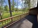 View from deck overlooking a landscaped lawn and mature trees providing shade and privacy at 830 Millerwood Dr, Lebanon, IN 46052