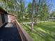 Deck overlooking the landscaped backyard, full of mature trees and lush green grass at 830 Millerwood Dr, Lebanon, IN 46052