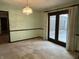 Inviting dining area with charming light fixture, chair rail, and door to outdoor space at 830 Millerwood Dr, Lebanon, IN 46052