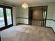 Dining area featuring doors to an outdoor area and an entry into a large living room at 830 Millerwood Dr, Lebanon, IN 46052