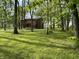 A two-story home is surrounded by lush greenery with mature trees at 830 Millerwood Dr, Lebanon, IN 46052