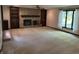 Spacious living room featuring a stone fireplace, built-in bookcases, and natural light at 830 Millerwood Dr, Lebanon, IN 46052