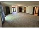 Large living room with multiple entry points and a large set of windows with a view to the back yard at 830 Millerwood Dr, Lebanon, IN 46052