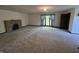 Spacious living room features a stone fireplace and natural light from the large window with blue drapes at 830 Millerwood Dr, Lebanon, IN 46052