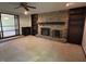 Living room with stone fireplace and dark built in shelving on either side at 830 Millerwood Dr, Lebanon, IN 46052