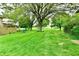 Exterior view of the large backyard area with a grass lawn and mature trees at 8360 Paso Del Norte Ct, Indianapolis, IN 46227