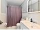 Bathroom with white tiled walls, shower curtain, and single vanity at 8360 Paso Del Norte Ct, Indianapolis, IN 46227