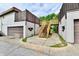 A two-story home featuring a garage and elevated wooden staircase leading to an upper entrance at 8360 Paso Del Norte Ct, Indianapolis, IN 46227