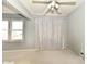 The living room features carpet and natural light from the window at 8360 Paso Del Norte Ct, Indianapolis, IN 46227