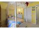 Bedroom featuring carpet, closet, and a yellow wall with a fun design at 8644 S Tibbs Ave, Indianapolis, IN 46217