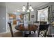Charming dining room with a round table, adjacent to the kitchen, bathed in soft natural light from the window at 8644 S Tibbs Ave, Indianapolis, IN 46217