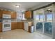 Bright kitchen featuring wooden cabinets, modern appliances, and a seamless transition to a sunroom with lake views at 8644 S Tibbs Ave, Indianapolis, IN 46217