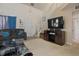 Spacious living room featuring plush seating, a modern TV setup, and a staircase leading to the upper level at 8644 S Tibbs Ave, Indianapolis, IN 46217