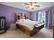 Cozy bedroom featuring an oak bedframe, plush pillows, and lots of storage at 8644 S Tibbs Ave, Indianapolis, IN 46217