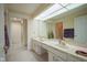 Bathroom featuring a dual sink vanity, large mirror, and ample countertop space at 8751 Jaffa Court East Dr # Apt 32, Indianapolis, IN 46260