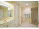 Clean bathroom featuring a well-lit vanity, mirrored cabinets, and a shower with a glass door at 8751 Jaffa Court East Dr # Apt 32, Indianapolis, IN 46260