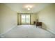 Bright bedroom featuring neutral walls, carpet flooring, and a window view with a desk at 8751 Jaffa Court East Dr # Apt 32, Indianapolis, IN 46260