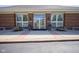 Exterior building entrance flanked by lion statues, planters, address numbers, and brickwork at 8751 Jaffa Court East Dr # Apt 32, Indianapolis, IN 46260