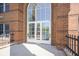 Exterior entrance featuring brick and a large arched window above double doors at 8751 Jaffa Court East Dr # Apt 32, Indianapolis, IN 46260