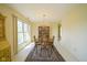 Traditional dining room with a wooden table, chandelier, and a view of the outdoor greenery at 8751 Jaffa Court East Dr # Apt 32, Indianapolis, IN 46260