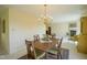 Open dining room with a view to the fireplace and kitchen, bathed in natural light at 8751 Jaffa Court East Dr # Apt 32, Indianapolis, IN 46260