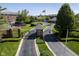 Community gated entrance with manicured landscaping, tennis court, and American flag waving in the breeze at 8751 Jaffa Court East Dr # Apt 32, Indianapolis, IN 46260