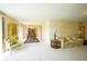 Bright and spacious living room featuring neutral walls and carpet, with a view into the dining area at 8751 Jaffa Court East Dr # Apt 32, Indianapolis, IN 46260