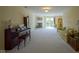 Spacious living room featuring a fireplace, piano, and neutral carpeting at 8751 Jaffa Court East Dr # Apt 32, Indianapolis, IN 46260