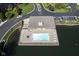 Aerial view of a community pool with lounge chairs surrounded by a lake and parking area at 8751 Jaffa Court East Dr # Apt 32, Indianapolis, IN 46260