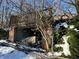 Dilapidated structure surrounded by snow-covered ground and bare winter trees and overgrowth at 8803 S Sleepy Hollow Rd, Waldron, IN 46182