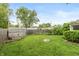 Spacious backyard featuring a lush lawn, privacy fence and storage shed at 916 S Outer Dr, Lebanon, IN 46052