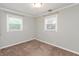 A bright bedroom features two windows, neutral walls, carpeted floor, and white trim at 916 S Outer Dr, Lebanon, IN 46052