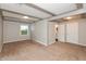 A bright carpeted bedroom features a window and doorways to a bathroom and hallway at 916 S Outer Dr, Lebanon, IN 46052