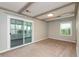 Bright bedroom featuring a sliding door leading to a sunroom and a neutral color palette at 916 S Outer Dr, Lebanon, IN 46052