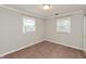 A carpeted bedroom featuring two windows and white trim at 916 S Outer Dr, Lebanon, IN 46052