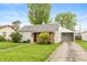 Cozy home with attached garage, green lawn, and mature trees at 916 S Outer Dr, Lebanon, IN 46052